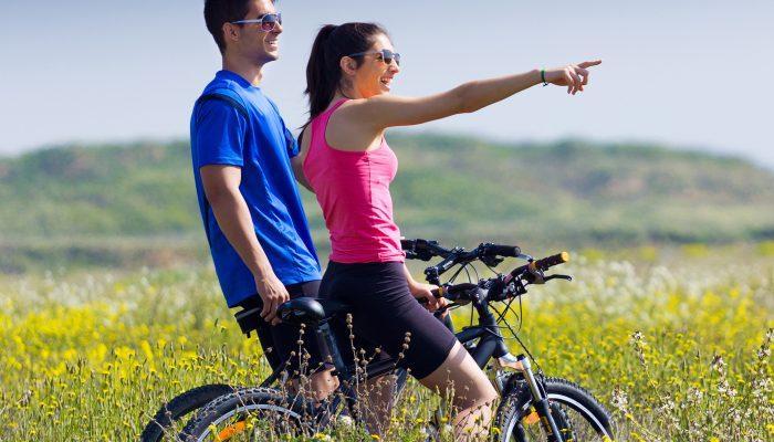 happy young couple on a bike ride in the countryside 1