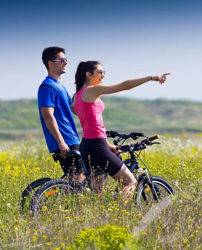 happy young couple on a bike ride in the countryside 1